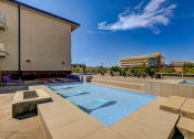 Thumbnail 24 of 33 - a pool on the rooftop of a building with a city in the background