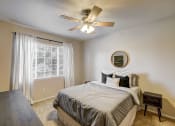 Thumbnail 27 of 32 - an empty bedroom with a bed and a ceiling fan