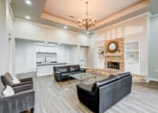 Thumbnail 11 of 32 - a living room with leather couches and a fireplace