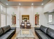 Thumbnail 14 of 32 - a living room with leather couches and a glass coffee table