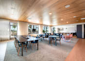 Thumbnail 22 of 43 - A modern dining room with a long table and chairs.