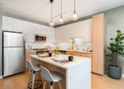 Thumbnail 8 of 43 - A modern kitchen with a dining table and chairs.