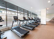 Thumbnail 30 of 43 - A gym with treadmills and a sign that says "Fit Yourself".