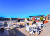 Thumbnail 27 of 34 - Luxury Apartments for Rent in Seattle - Union Bay - Rooftop with Outdoor Furniture, View of The City, and Planted Trees