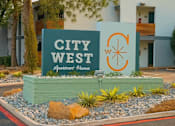Thumbnail 1 of 14 - A sign for City West Apartment Homes is displayed in front of a building.