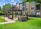 Thumbnail 43 of 48 - a patio with a gazebo in front of an apartment building