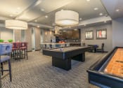 Thumbnail 18 of 33 - a game room with a pool table and a bar