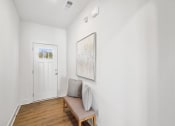 Thumbnail 6 of 25 - a living room with a couch and a door