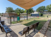 Thumbnail 41 of 48 - a park with benches and a fence and a tennis court