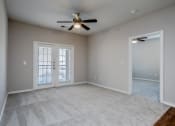 Thumbnail 36 of 48 - an empty living room with a ceiling fan and window