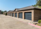 Thumbnail 47 of 48 - a row of garage doors on a brick building