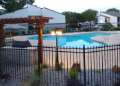 Thumbnail 8 of 19 - a swimming pool with a pavilion and a fence around it