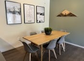 Thumbnail 20 of 40 - a dining room with a wooden table and grey chairs