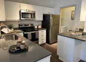 Thumbnail 17 of 40 - a kitchen with white cabinets and stainless steel appliances