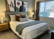Thumbnail 28 of 40 - a bedroom with a bed and two night stands with lamps