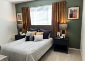 Thumbnail 25 of 40 - a bedroom with a large bed in front of a window