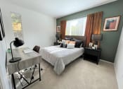 Thumbnail 24 of 40 - a bedroom with a bed and a desk
