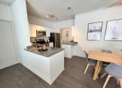 Thumbnail 19 of 40 - a kitchen and dining area in a 555 waverly unit