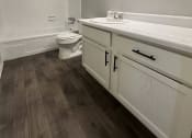 Thumbnail 19 of 19 - a bathroom with a toilet and a sink and a mirror