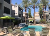Thumbnail 4 of 24 - Ingleside pool with green umbrellas and palm trees