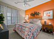 Thumbnail 8 of 48 - Riverstone - Bedroom with Orange Accent Wall, Side Tables, Lamps, and Decor