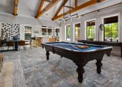 Thumbnail 23 of 48 - Riverstone - Newly Renovated Clubhouse with Large windows, Billiards Table, Sitting Area, and Demonstration Kitchen