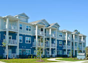 Thumbnail 2 of 65 - Apartment complex with blue and white buildings and a sign that says "ANNEXE".