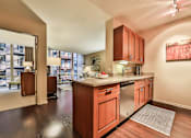 Thumbnail 26 of 28 - A kitchen with wooden cabinets and a stainless steel refrigerator.