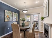 Thumbnail 3 of 24 - A dining room with a table and chairs.