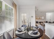 Thumbnail 2 of 47 - a dining room with a table and chairs