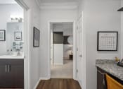 Thumbnail 11 of 47 - hallway leading to the bedroom with a bathroom and built-in desk