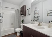 Thumbnail 20 of 47 - a bathroom with a sink and a toilet and a shower