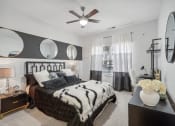 Thumbnail 12 of 47 - a bedroom with a bed and a ceiling fan