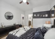 Thumbnail 13 of 47 - a bedroom with a black and white bed and a mirror