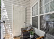 Thumbnail 23 of 47 - covered patio with a white door and chairs