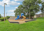 Thumbnail 44 of 47 - a playground with a blue and yellow slide in a park