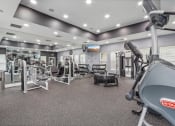 Thumbnail 30 of 47 - a gym with weights and cardio equipment at the enclave at university heights