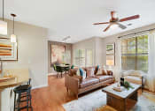 Thumbnail 7 of 48 - a living room with a couch and a ceiling fan