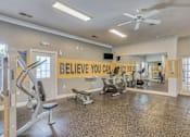 Thumbnail 11 of 20 - A gym with a sign that says "Believe You Can" on the wall.