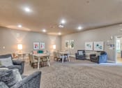 Thumbnail 14 of 20 - A spacious living room with a grey carpet and furniture.