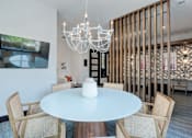 Thumbnail 23 of 47 - A white table with chairs and a chandelier in a room.