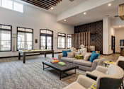 Thumbnail 18 of 47 - A living room with a grey carpet and a wooden ceiling.
