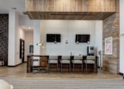 Thumbnail 22 of 47 - A modern kitchen with a dining table and chairs.