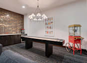 Thumbnail 26 of 47 - A room with a pool table and a red bicycle.