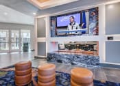 Thumbnail 12 of 37 - Game room and lounge with TV and gas fireplace