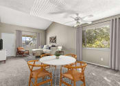 Thumbnail 5 of 19 - Living room with carpet flooring, equipped with a ceiling fan for added comfort, and large windows which invite ample natural light into the space.