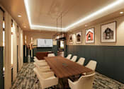 Thumbnail 6 of 29 - a conference room with a wooden table and chairs and pictures on the wall
