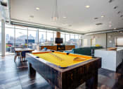 Thumbnail 9 of 31 - a pool table in a party room with a view of the city