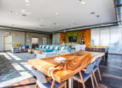 Thumbnail 8 of 31 - a living room and dining room with a wooden table