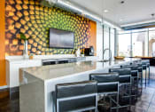 Thumbnail 11 of 31 - a bar with chairs in front of a counter and a yellow wall